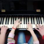 kids-many-hands-on-piano