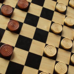 a wooden draughts or checkers with wooden counters